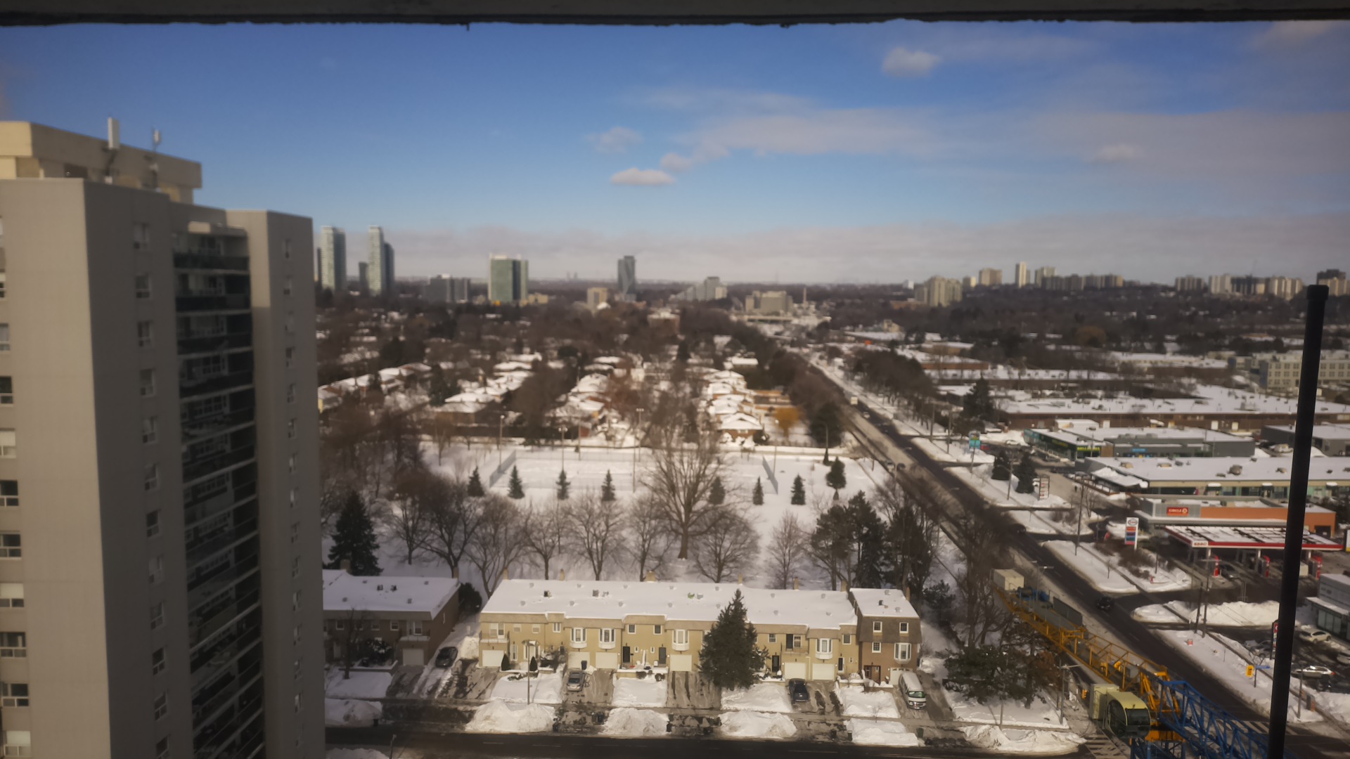 The camera's view at noon in January 2026: snow on the ground and a clear blue sky