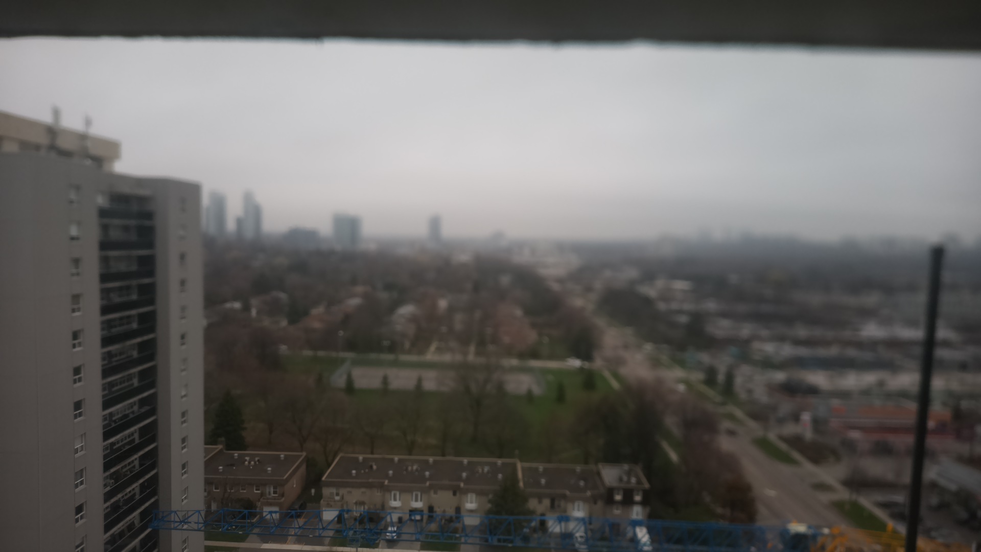 The camera's view at noon in April 2026: fog hiding the towers on the horizon